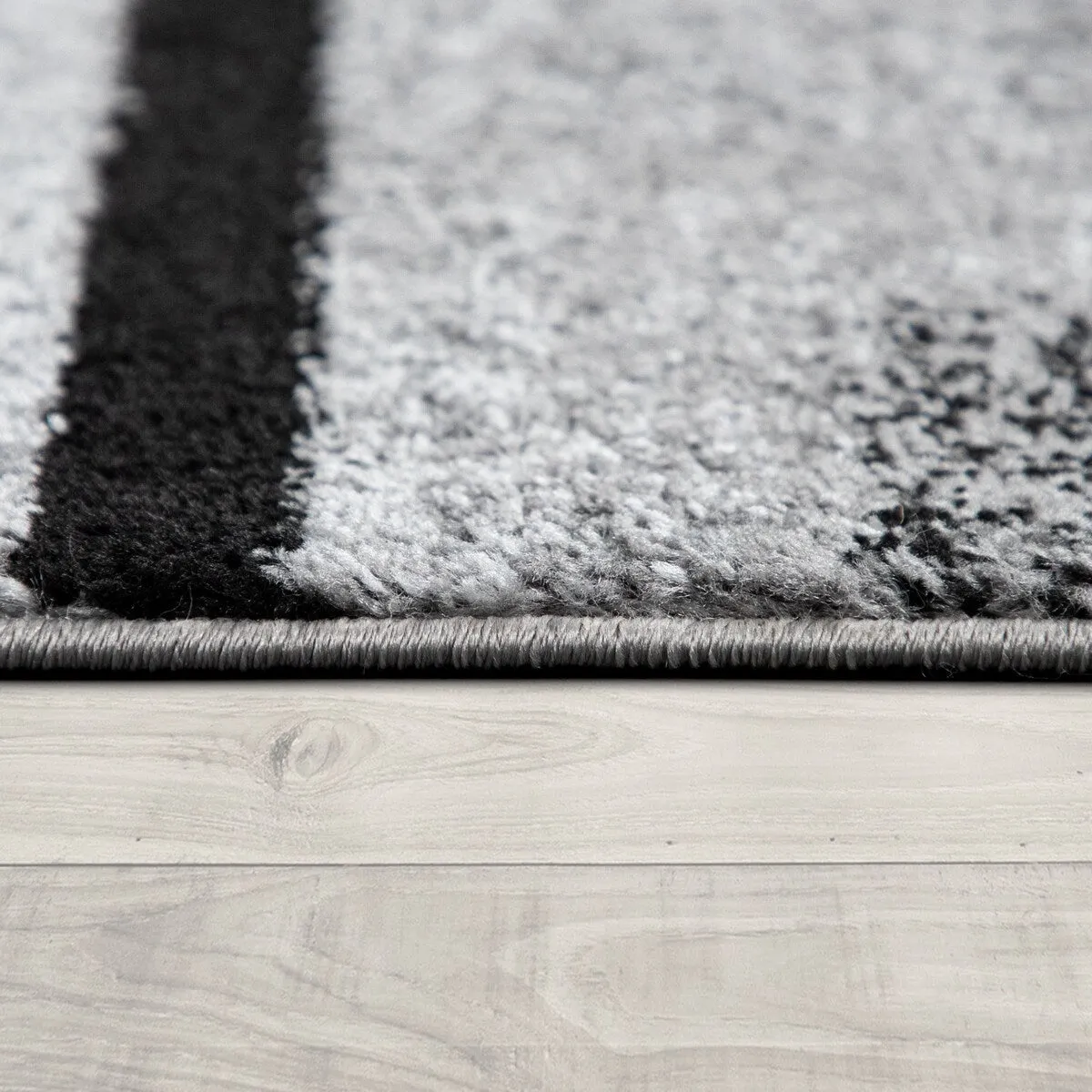 Black White Area Rug with Geometric Pattern and Modern Paint Effect